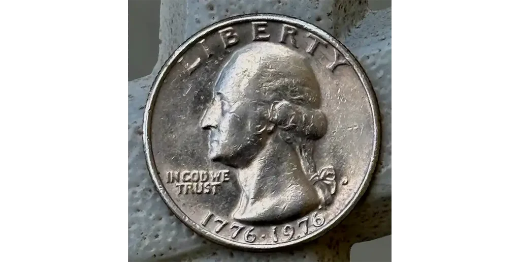 a quarter with the motto IN COD WE TRUST.